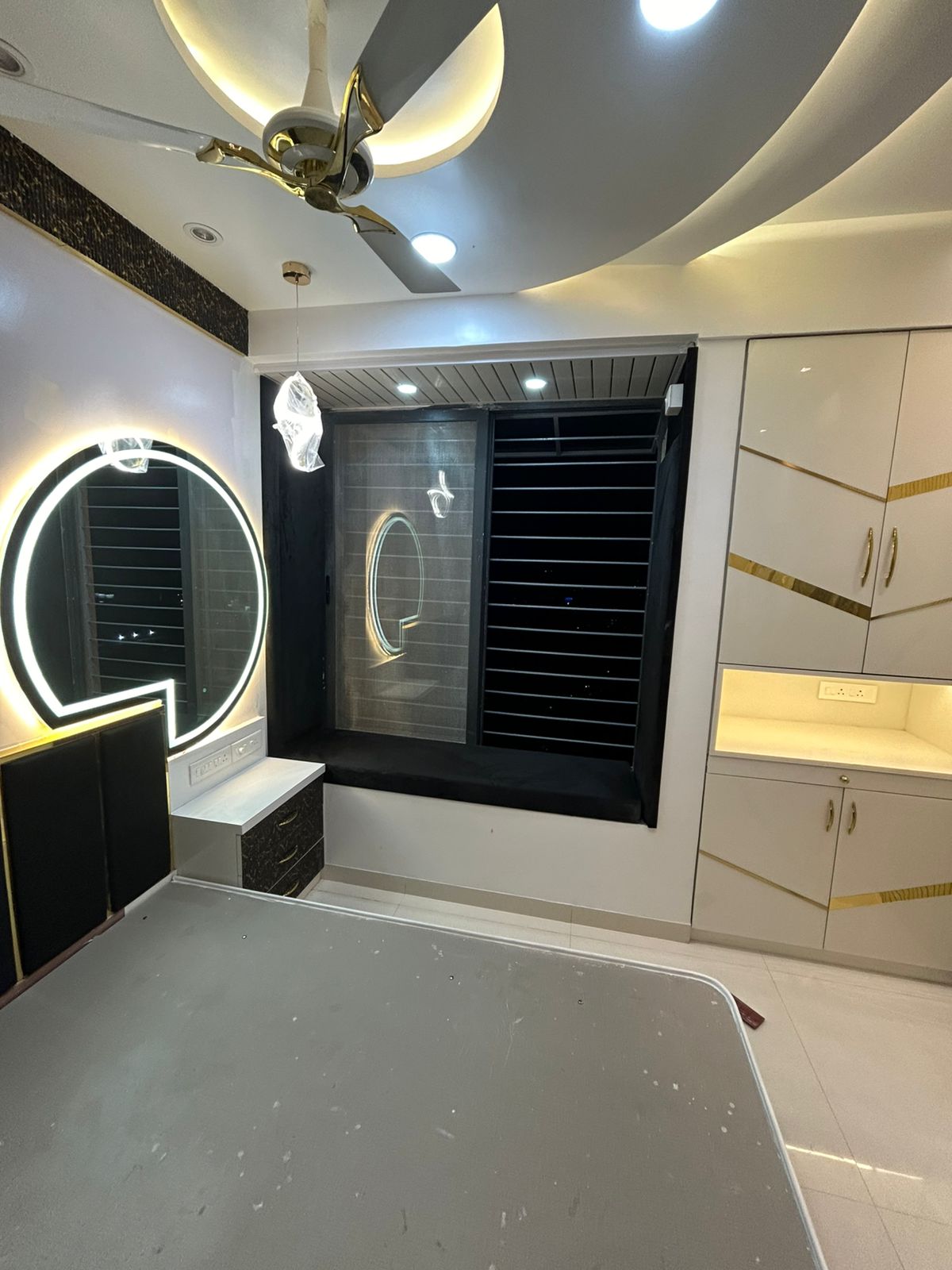 Modern false ceiling with cove lighting in a Pune bedroom